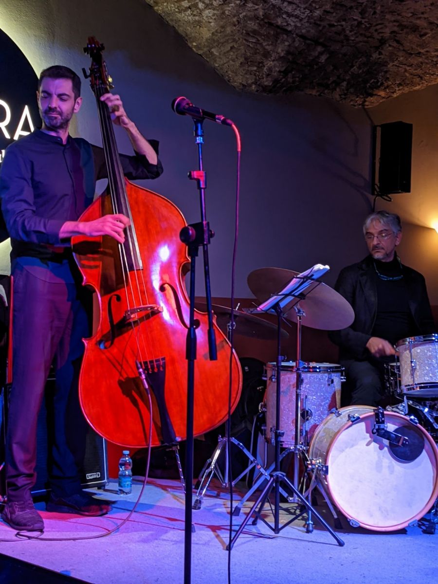 Upright bassist and drummer playing a tune