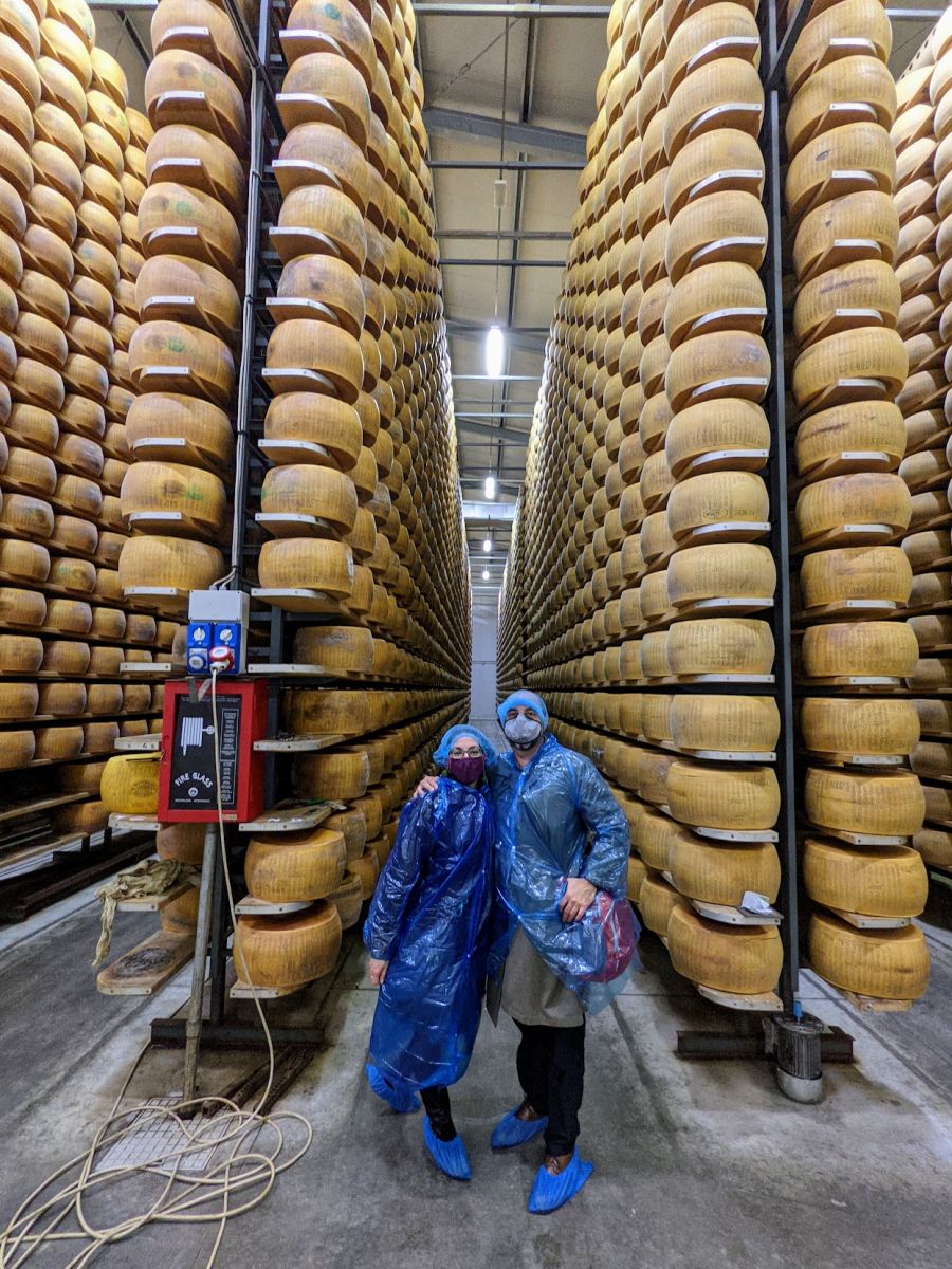 Teresa and I standing in front of stacks of cheese