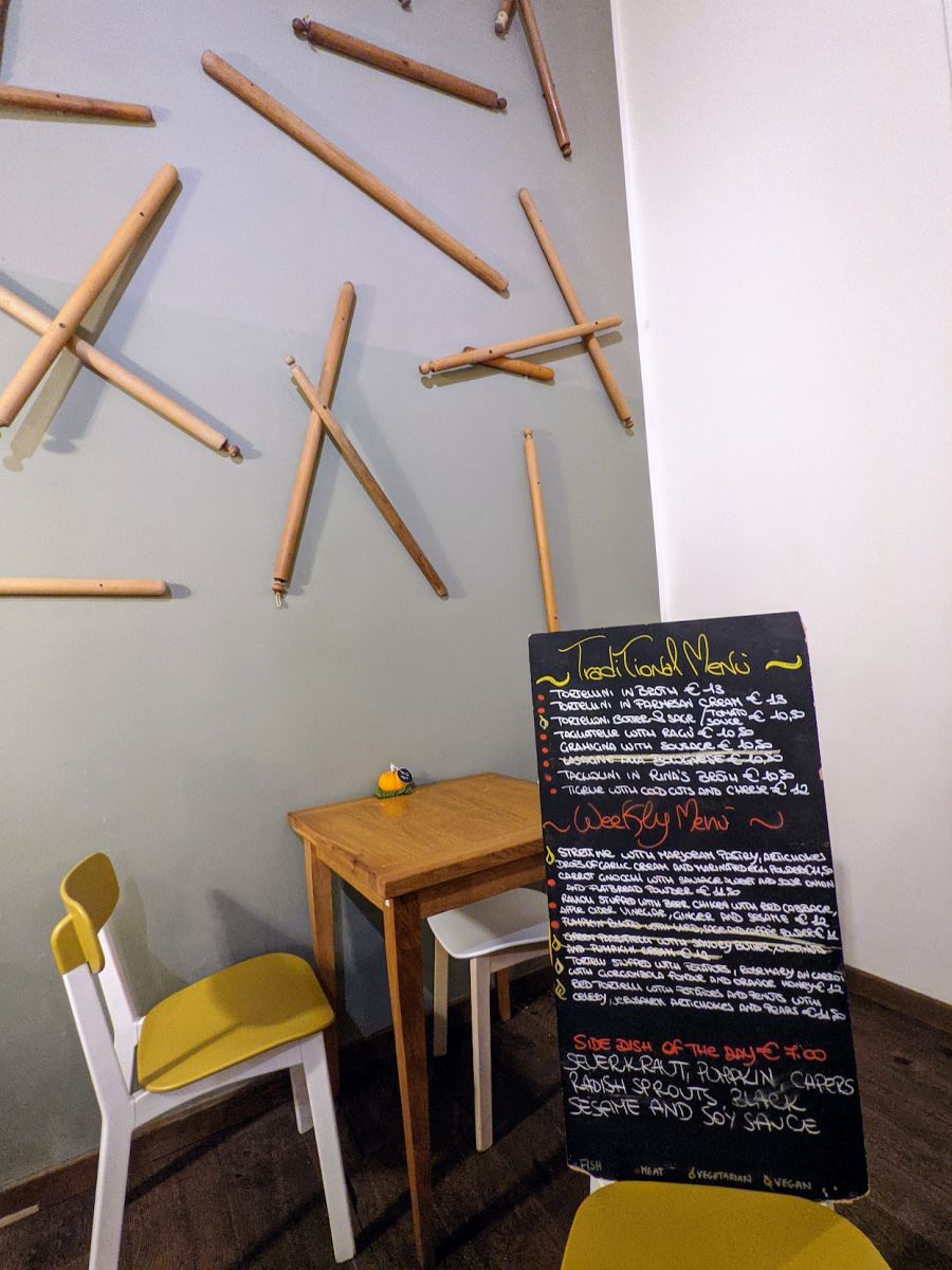 A wall with numerous mattarelli (Italian pasta rollers) as decoration