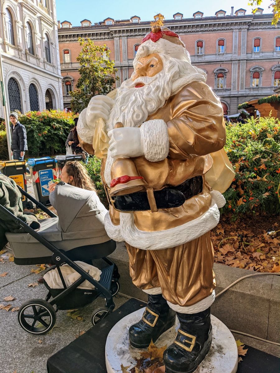 A Santa statue near a Christmas Market