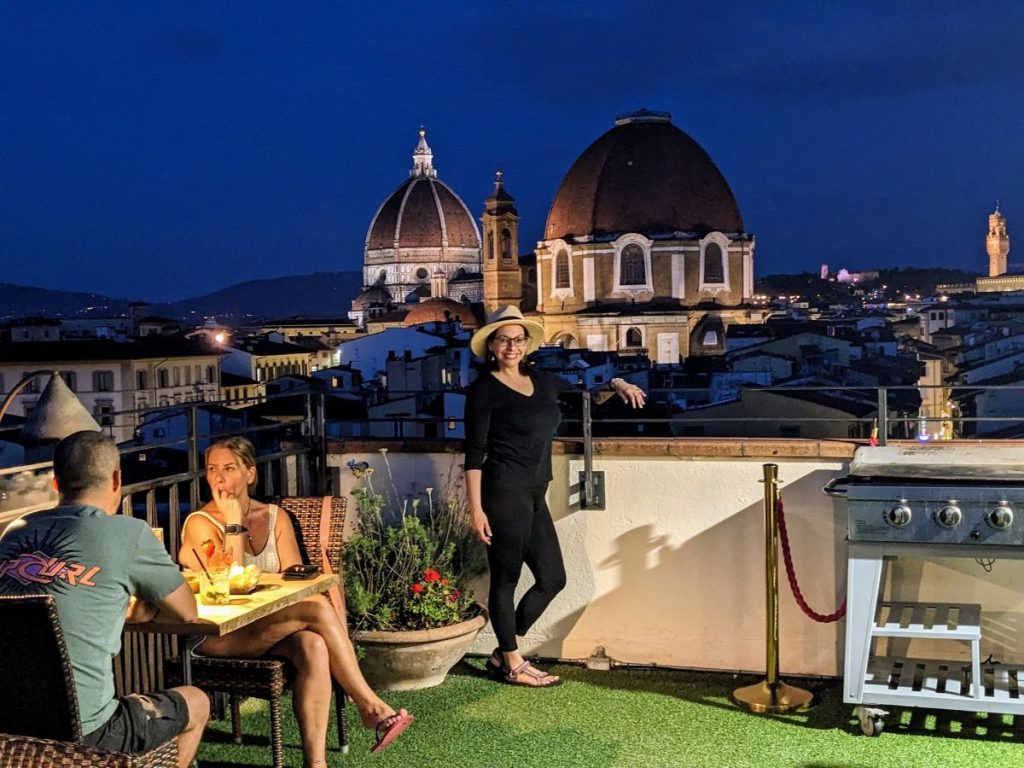 Teresa standing on the rooftop bar of our hotel, with the Duomo in the background