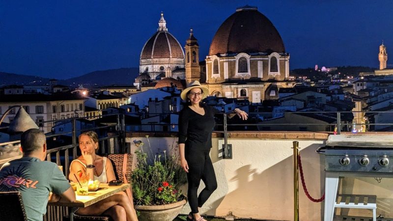 Teresa standing on the rooftop bar of our hotel, with the Duomo in the background