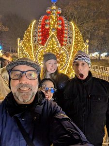 The four of us posing in front of a light display
