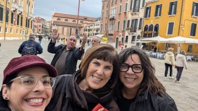 Teresa, Janet, Sheri, Hugh, and Gordon posing for the camera in a piazza in Venice