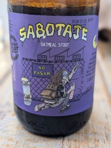 Sabotaje beer label - purple, with a drawing of someone tagging a wall with a skateboard next to them.